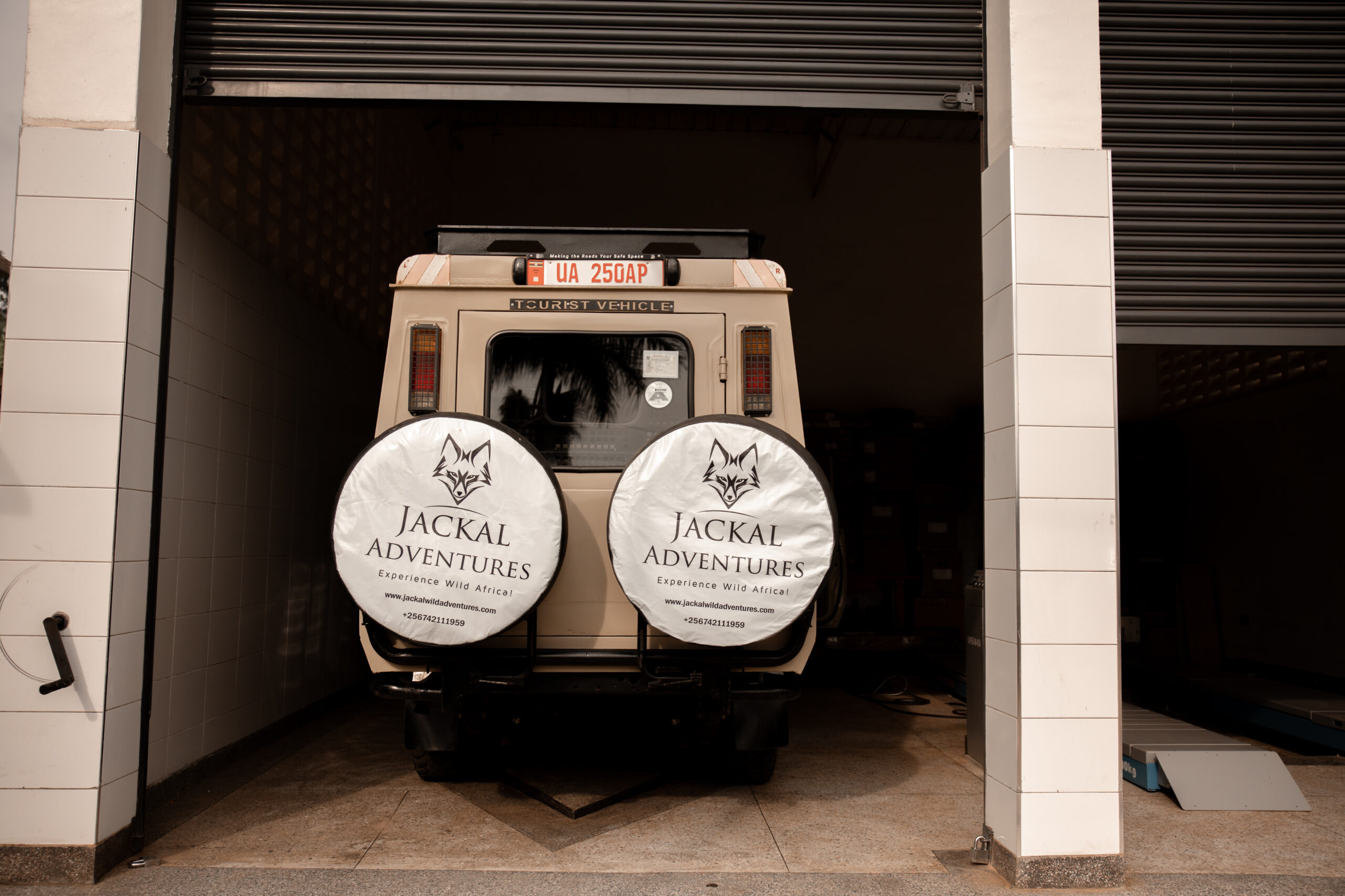 The rear of a Jackal Adventures safari Land Cruiser showing its two branded onboard spare tires
